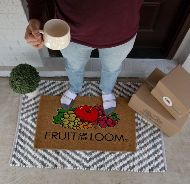 man holding coffee mug wearing fruit of the loom socks getting his subscription package